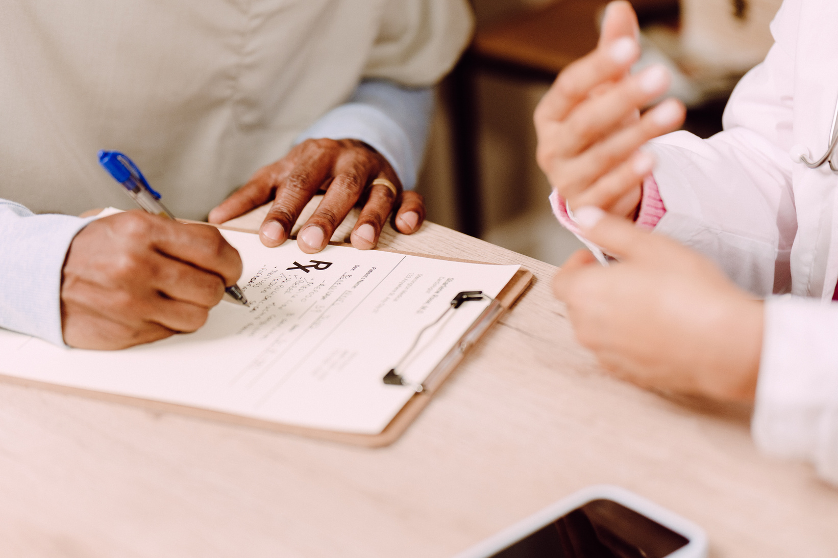 Nurse Writing Prescription with Doctor's Guidance